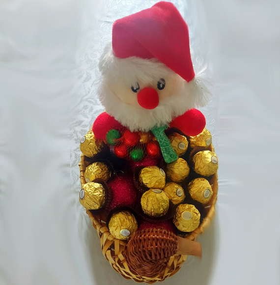 4 Chccolates, 3 biscuits and a sweet white non-alcoholic sparkling drink wrapped in a Christmas Decorative Bottle Cover